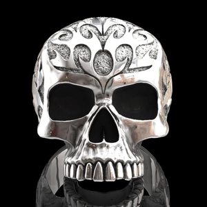 Detailed view of punk skull ring featuring intricate floral engraving on silver metal