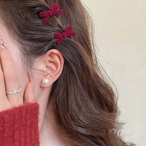 Elegant wine red velvet bow hair clips for women shown on model hair for a vintage look