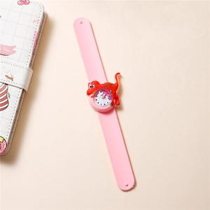 Macro shot of pink silicone slap watch featuring a cute 3D cartoon dinosaur for kids