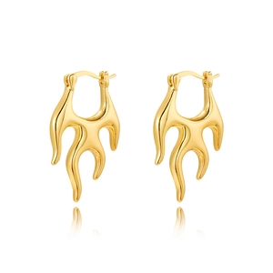 Detailed macro shot of 18k gold fluid flame earrings with a high-polish mirror finish