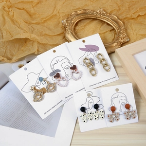 Mixed set of 5 stylish earrings including gold Saturn, pearl hearts, and bow designs