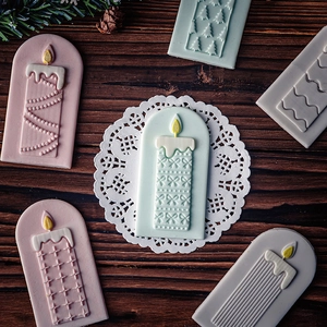 Christmas candle fondant molds for festive DIY cake and cookie decorations on wood table
