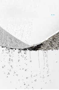 Macro shot of grey non-slip TPE bath mat showing efficient water drainage and hole structure