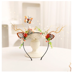 Detailed close-up of a DIY Christmas antler headband with berries and butterfly