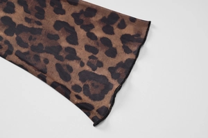 Macro detail of leopard print mesh fabric showing delicate stitching and texture
