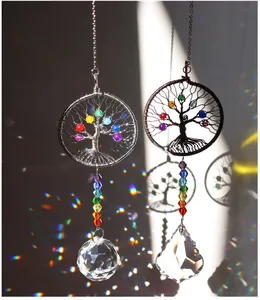 Detail of Tree of Life crystal suncatchers casting rainbow light and shadow patterns