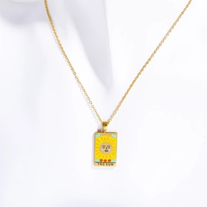Golden stainless steel Tarot card necklace featuring The Sun enamel pendant on white background