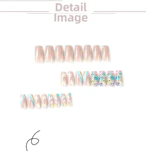 Close-up of pink press-on nails with daisy, rainbow smiley face and polka dot patterns