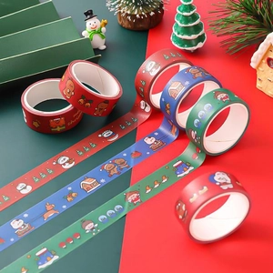 Close-up of decorative Christmas washi tape rolls with festive cartoon patterns