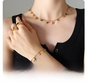 Detail of 18k gold plated titanium steel set with colorful zircons on a model