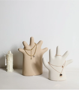 Artistic hand-shaped ceramic jewelry stand in matte beige and smooth white finish