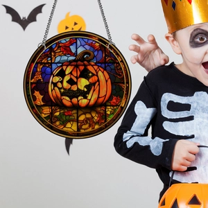 Halloween pumpkin acrylic ornament with colorful glass style held by a child