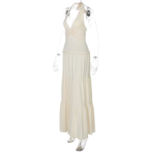 Detail of cream halter neck maxi dress with deep V-neck and twist knot design