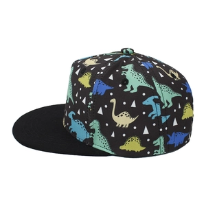 Detail of kids black snapback hat featuring colorful cartoon dinosaur prints and flat brim