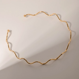 Detail of minimalist 18k gold plated stainless steel wavy choker with ball ends