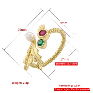 Detail of adjustable gold ring with twisted texture, white pearl and colored gemstones