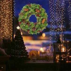 Close-up of a Christmas wreath with green pine needles, red berries, and natural pine cones