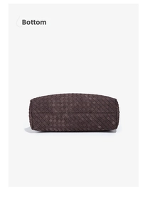 Detail view of woven leather tote bag bottom showing professional Intrecciato craftsmanship