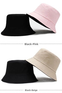 Detailed view of reversible cotton bucket hats in black-pink and black-beige combinations