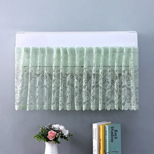 Detail of light green lace AC dust cover featuring floral mesh and scalloped edges