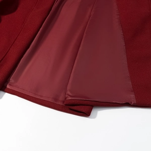 Close-up of deep red woolen coat showing premium fabric texture and smooth inner lining