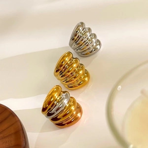 Set of three textured wave rings in gold, silver, and tricolor polished metal