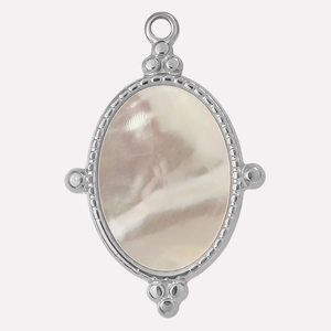 Detailed macro view of oval stainless steel pendant with white mother of pearl inlay