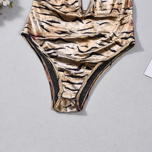 Detailed view of the tiger print velvet texture and bottom cut of the bodysuit