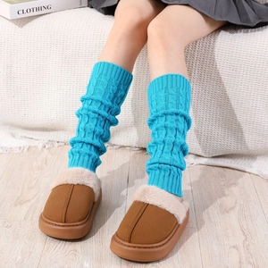 Close-up of cable knit pattern and warm lining on sky blue leg warmers for women