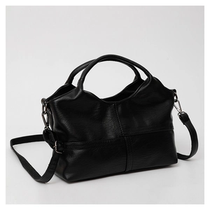Close-up of black soft leather texture and metal buckle detail on a large tote bag