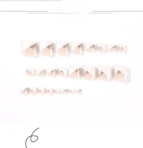 Detail of pink and white french toe nail tips with gold glitter geometric patterns