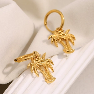 Macro shot of gold-plated stainless steel coconut tree earrings with a glossy finish