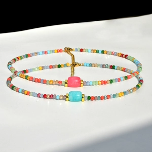 Detail of colorful faceted crystal bead necklaces with gold metal accents and extender chain
