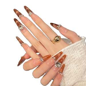 Amber cat-eye press-on nails with tea brown gradient pearls and shimmering rhinestones