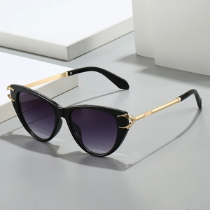 Cat eye sunglasses with gradient lenses and gold metal temples on a modern display