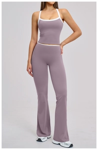 Detail of high-waisted flared yoga pants and crop top with contrast white piping