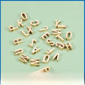 Detailed view of 26 gold brushed stainless steel alphabet beads with side holes for DIY jewelry