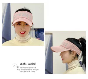 Pink knit sports visor for women with SPORT logo showing front and side views