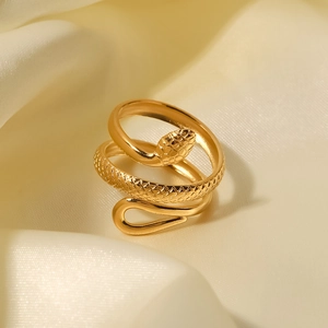 Adjustable 18K gold plated snake ring with detailed scale texture on cream silk