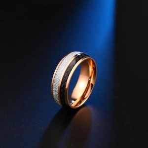 Macro detail of 8mm stainless steel ring with silver meteorite and black carbon fiber inlay