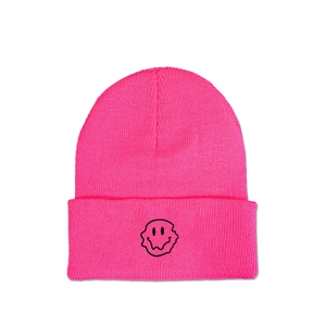 Close-up of pink knit beanie showing detailed texture and melting smiley face embroidery
