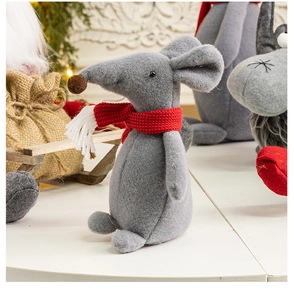 Detailed view of a grey felt mouse ornament with red knitted scarf on a white table