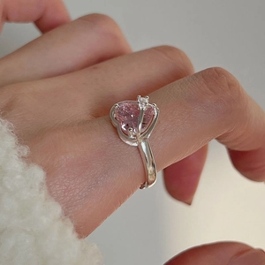 Pink heart gemstone ring with silver band in a minimalist design worn by a model