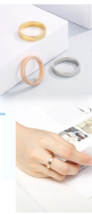 Close-up of three 4mm mirror polished stainless steel rings in gold, silver and rose gold