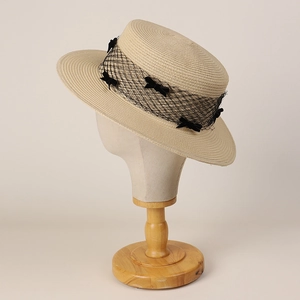 Japanese style boater hat with black mesh veil and ribbon bows on cream straw base