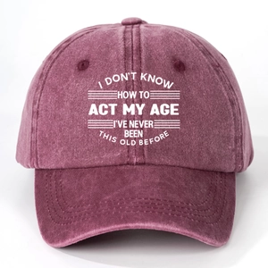 Close-up of vintage washed cotton baseball cap with printed humorous white text quote