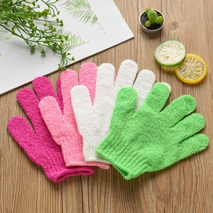 Exfoliating five-finger bath gloves in assorted colors on a rustic wooden table background