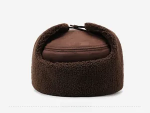 Rear view of brown winter earflap hat featuring faux suede top and thick sherpa fleece lining