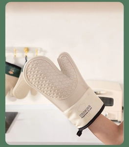 Detail of cream silicone oven glove with non-slip diamond texture and hanging loop