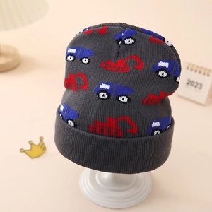 Detail view of baby knit hat with cartoon excavator patterns and warm folded brim
